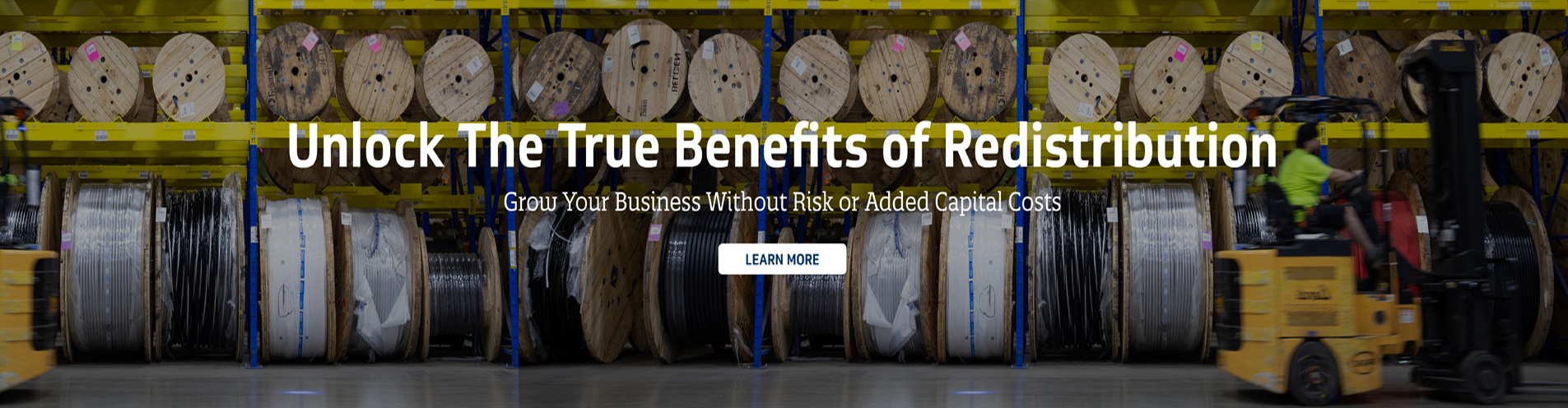 Warehouse image of cable reels and a pallet jack
